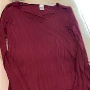 Maroon long sleeve top with cross cross chest.